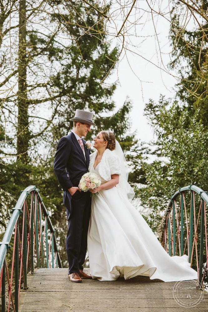 Chippenham Park wedding photography, the bride and groom photographed on the bridge