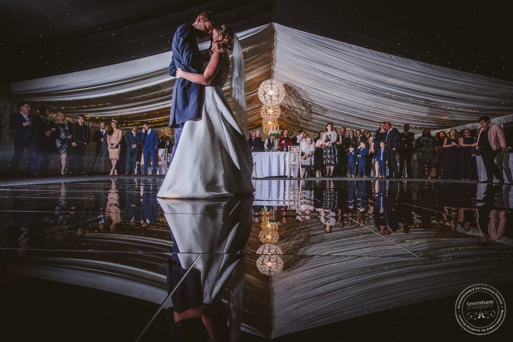 The first dance at Chippenham Park, with the bride and groom photographed in the reflection of the dancefloor