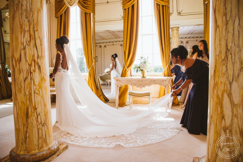 The bride in her wedding dress in Gosfield Hall's Rococco suite