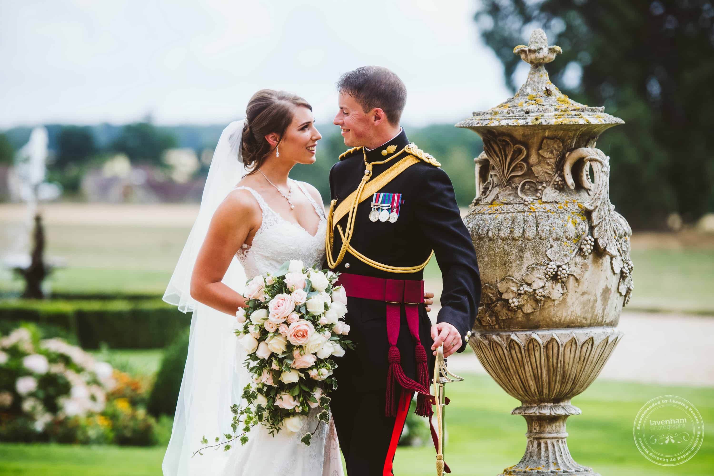 Wedding photography at Gosfield Hall with stone textures on the urn in the grounds and fountain and flowerbeds looking great in the background