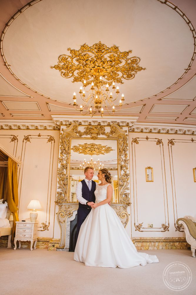 The bride and groom photographed in Gosfield Hall's Rococo suite