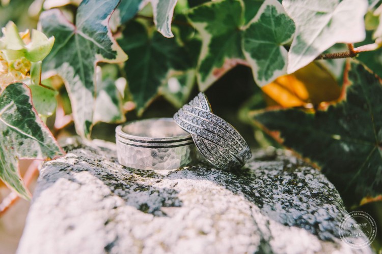 Wedding rings photographed in detail against stone