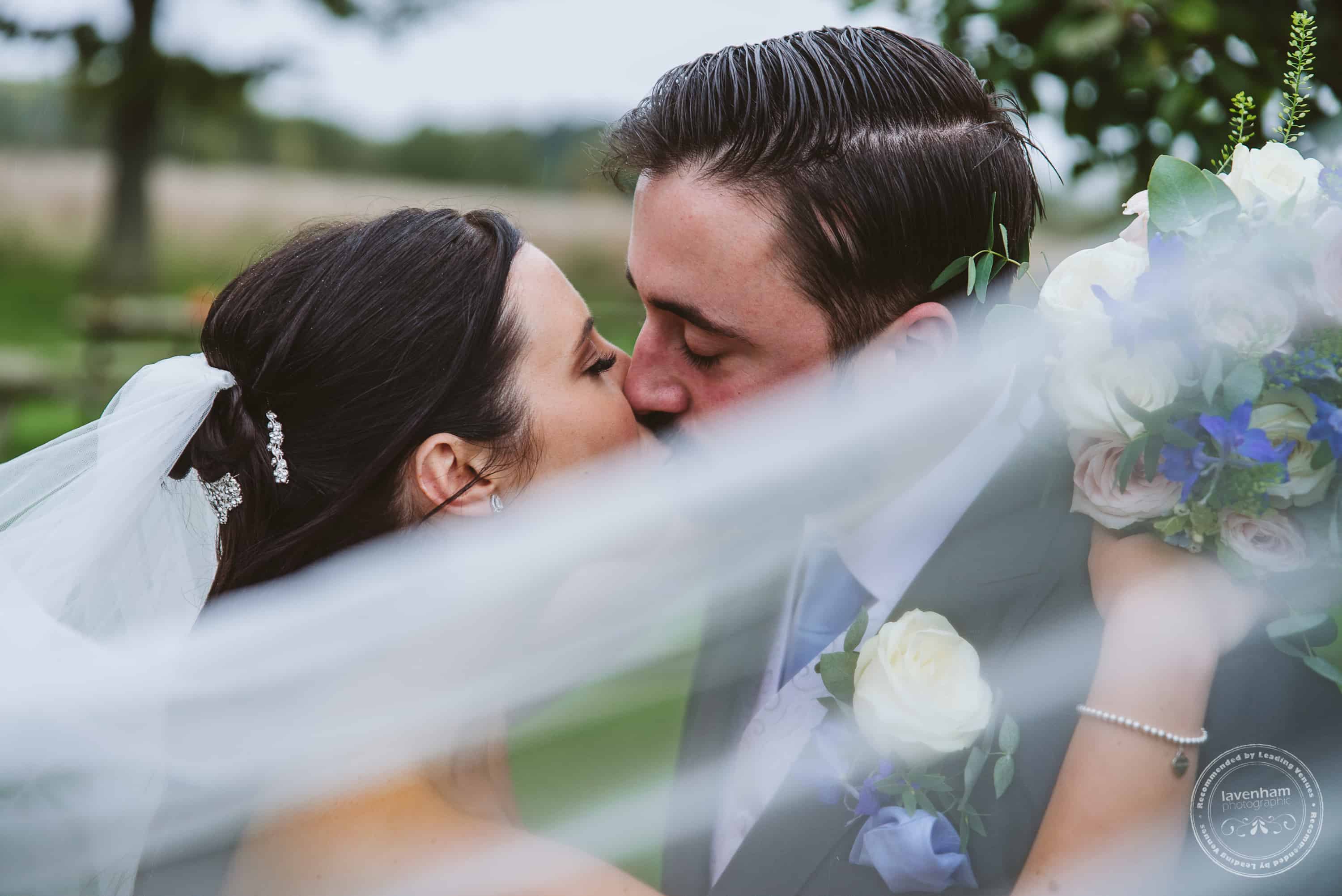 Wedding Photograph of Bride and groom with wedding veil flying through the frame